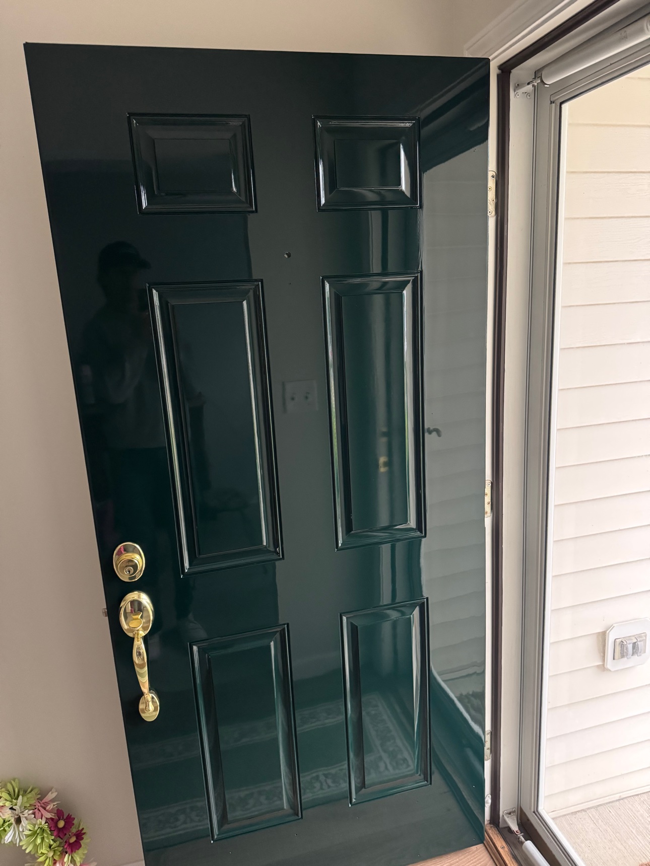 The finished high-gloss door reinstalled with polished brass hardware