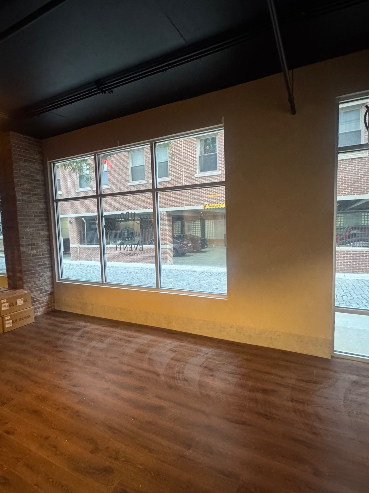 Warm metallic wall in a commercial event space with storefront windows